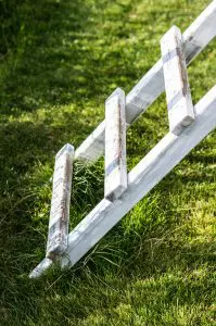 vertical shot white wooden ladder grass park Armaq